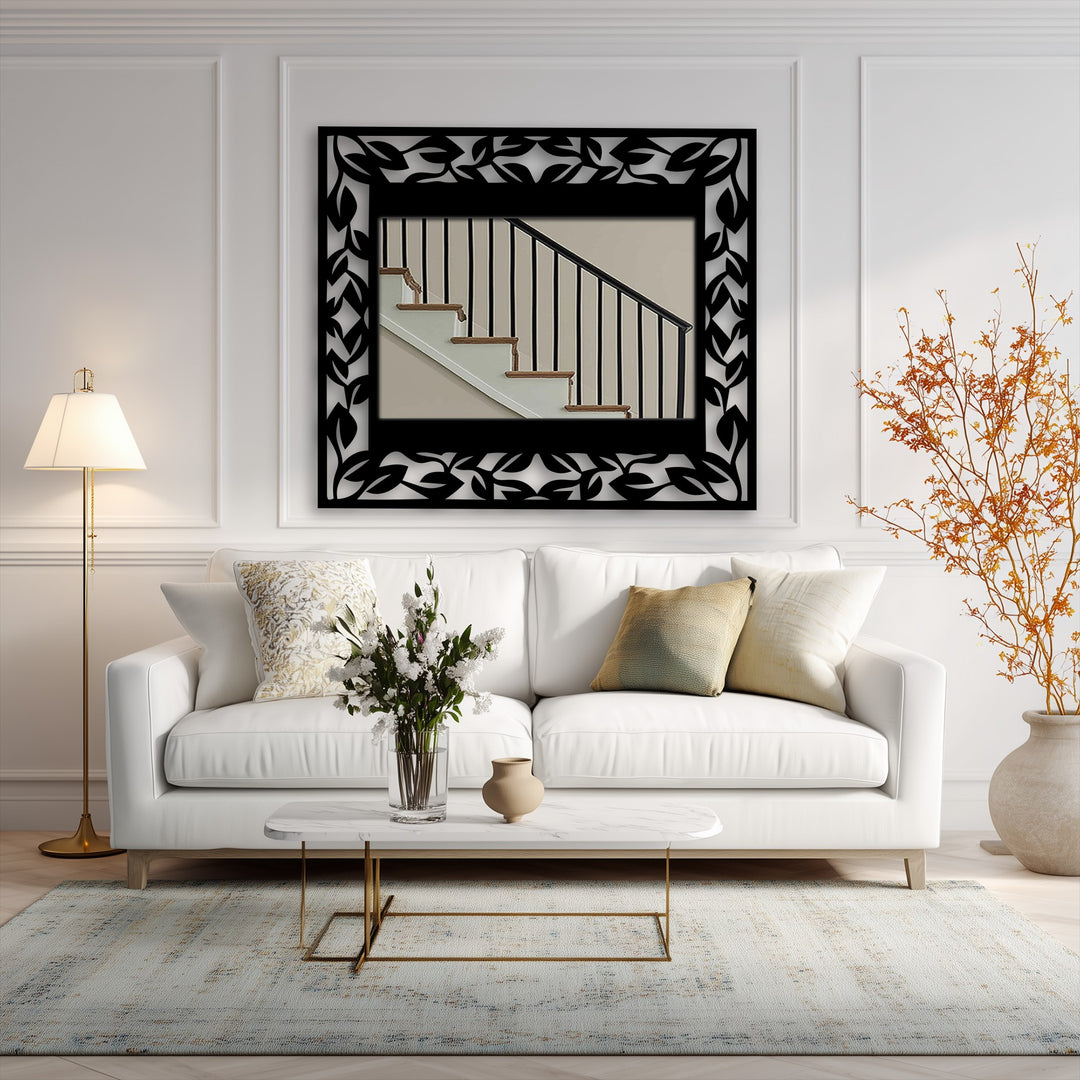 Evoking a serene and sophisticated mood, the leaf pattern frame around the metal artwork wall mirror adds an elegant botanical touch to the room's decor.