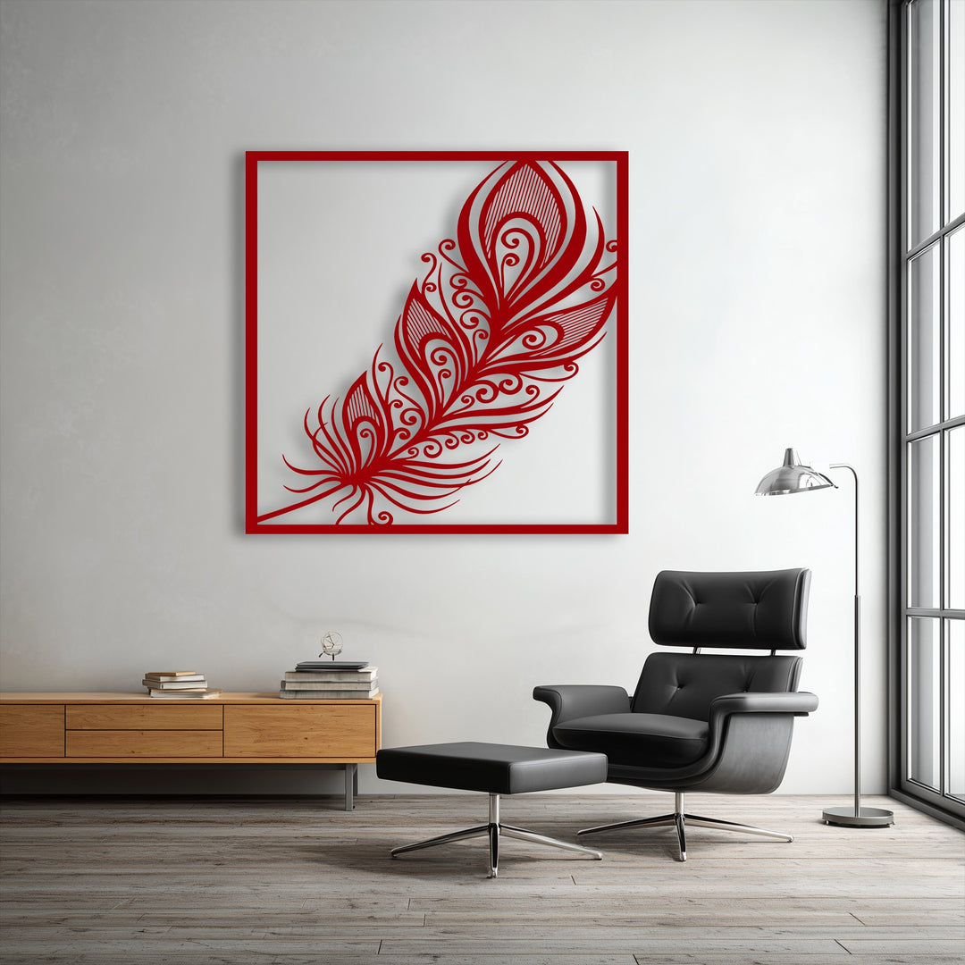 Striking light casts a deep shadow behind the intricate red ornate feather unique metal wall art, highlighting its elegant swirl plume design.
