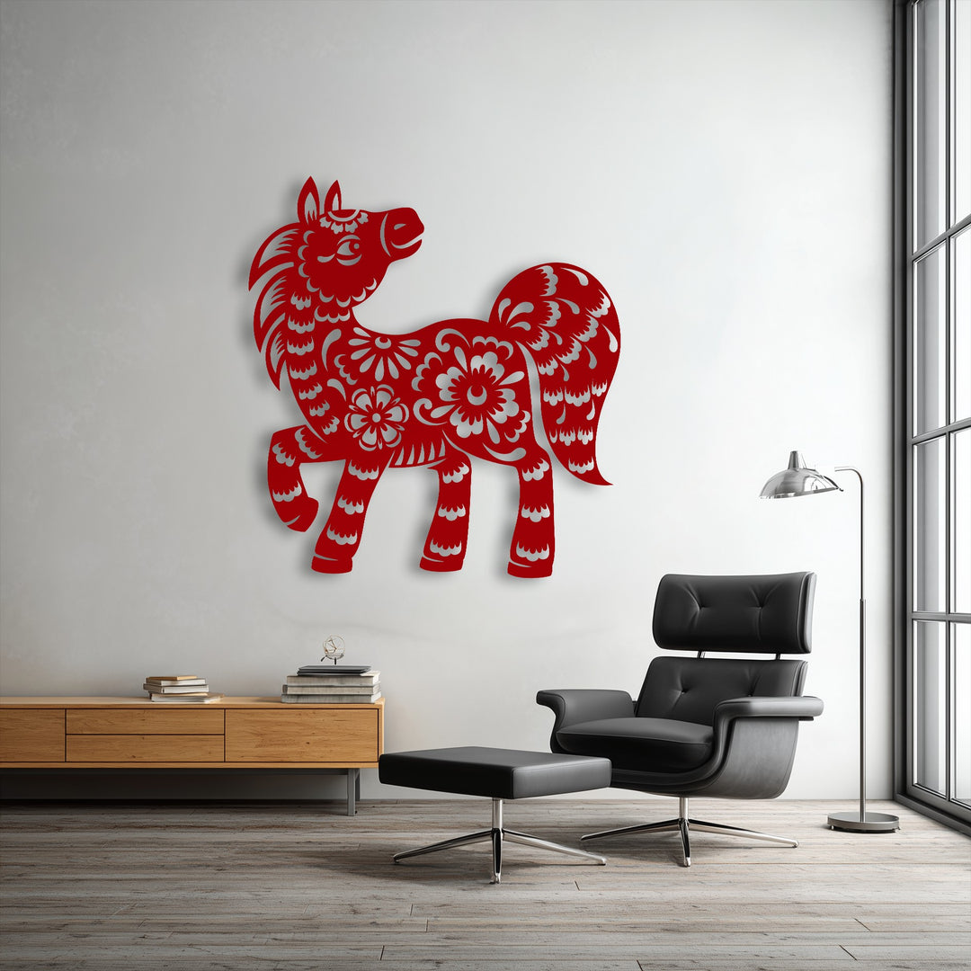 A vibrant red, intricately detailed floral pony silhouette provides a charming focus as metal wall decor on a white wall.