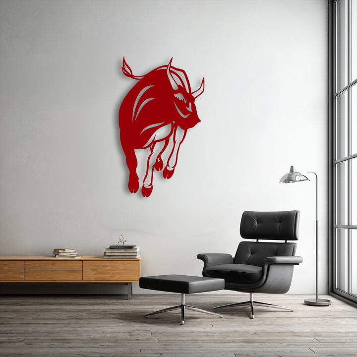 A sleek black leather armchair and matching ottoman sit on a wooden floor, complementing the bold charging bull metal art for wall above.