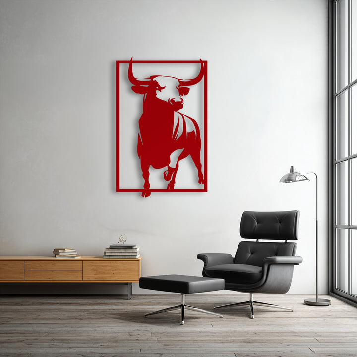 The bold geometric lines of the red bull metal wall art in a rectangular frame create a striking piece of decorative metal art.