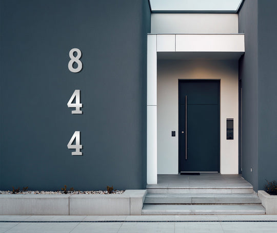 Edges and borders are highlighted in this modern address number display, a metallic decoration wall art piece lending a minimalist touch to any home's exterior.