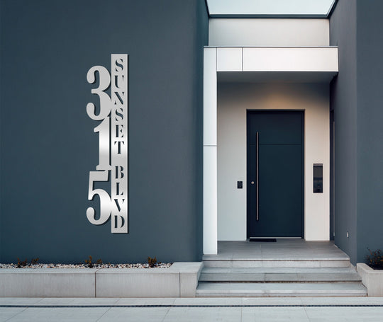 Metal artwork featuring a modern, vertical metal house number display with address numbers and street name is the focal point.