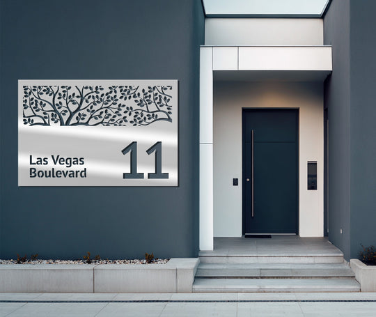 Visual rhythm created by the repeating branch and leaf pattern makes this decorative tree address sign a beautiful piece of metal artwork on the home's exterior.