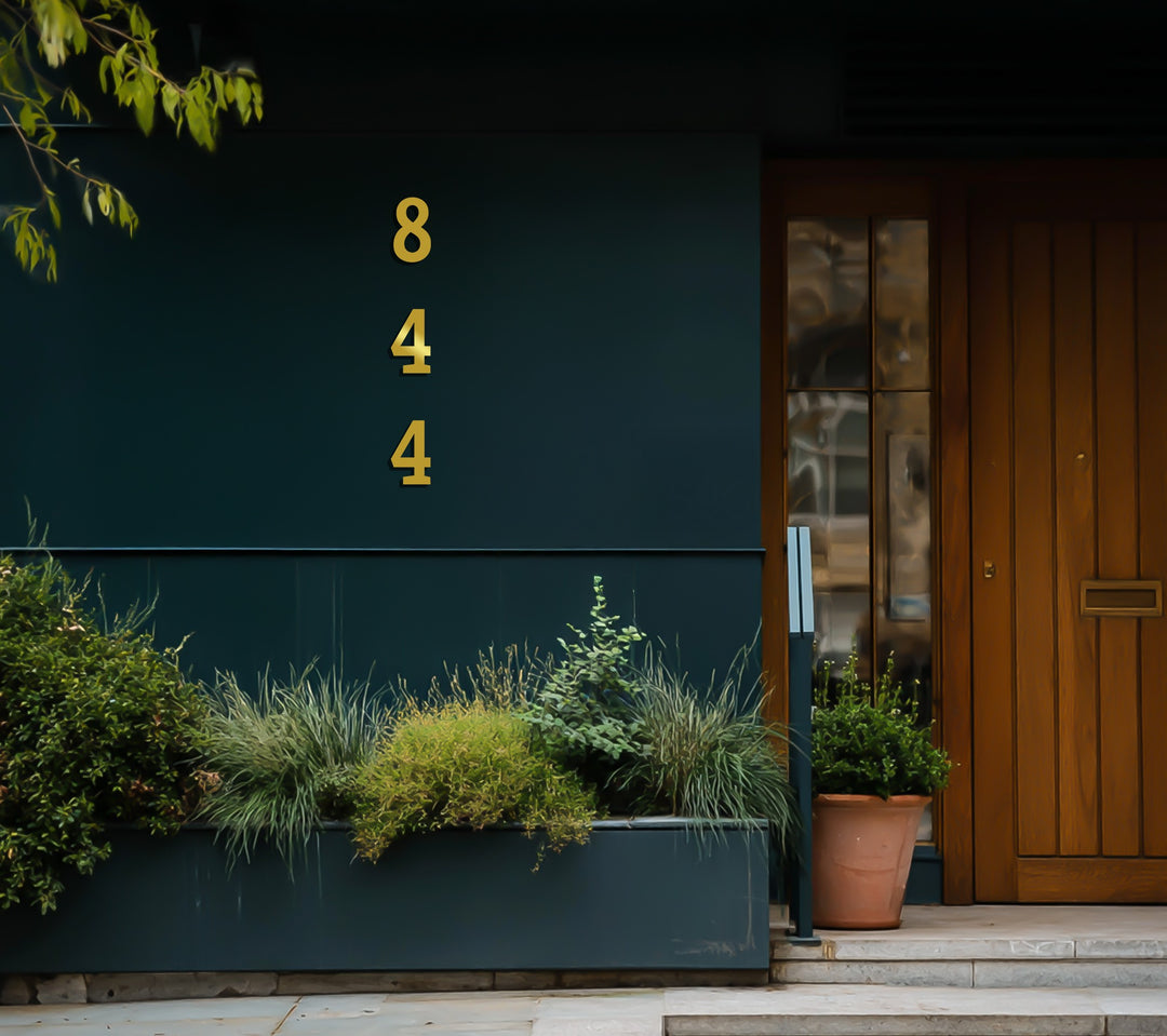 Black vertical metal house number decor