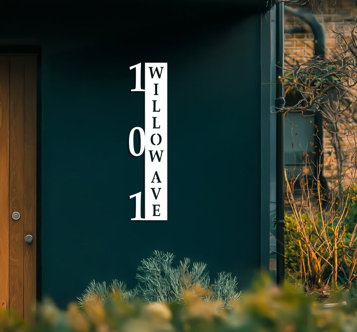 Black vertical metal house number welcome display