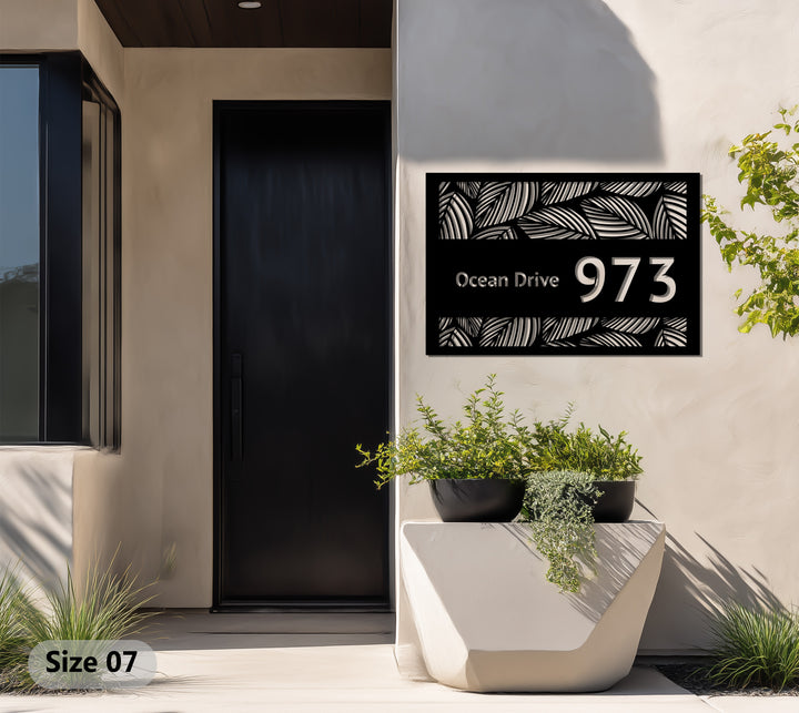 Modern black metal house plaque with leaf pattern
