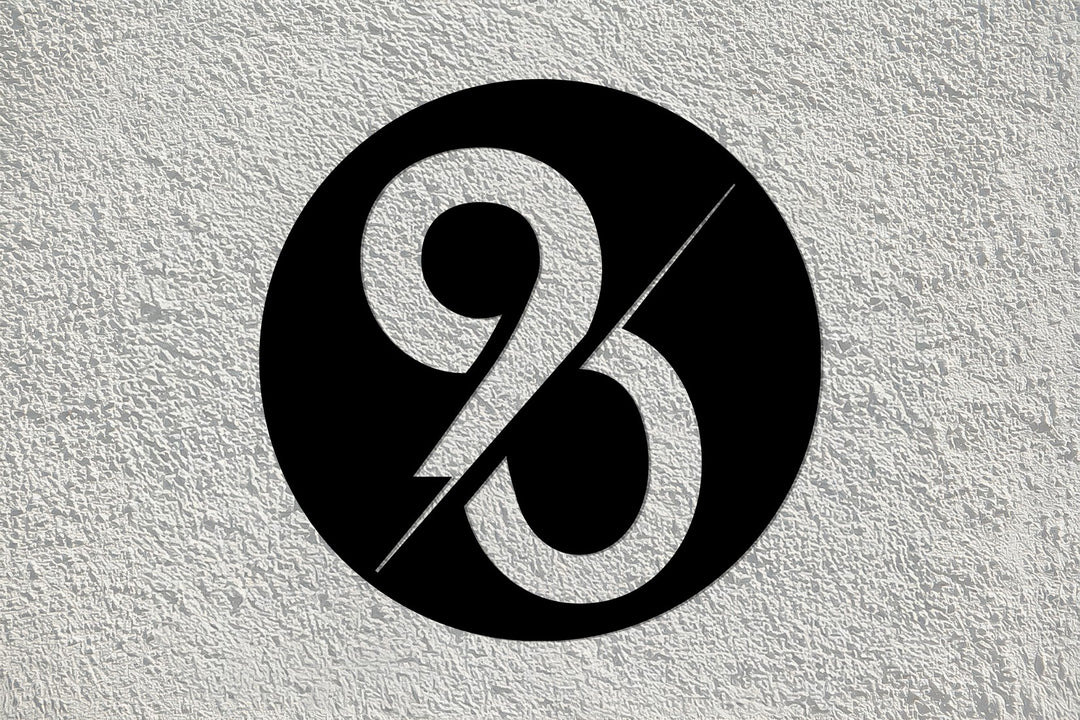 Bold typography circular metal wall sign