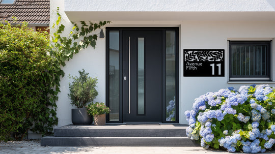 Highlighting its abstract quality, the decorative metal art of the address sign features a leaf cutout creating a modern pattern with the house number and street name.