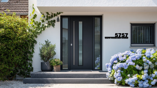 The stillness of the scene emphasizes the decorative metal art of the modern address numbers with street name mounted beside the window.