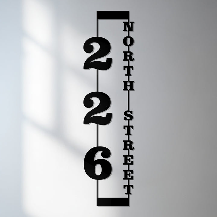 Vertical metal house numbers with street name sign