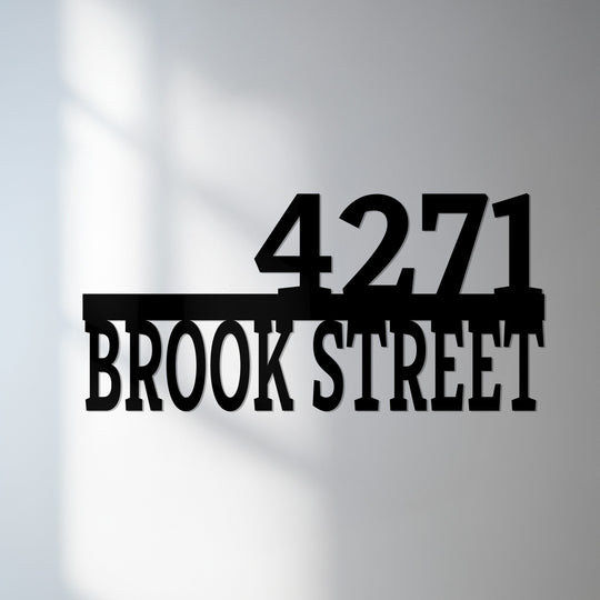 Displaying modern address numbers with street name, this horizontal metal house number sign makes striking metal wall decor for an eye-catching entrance.
