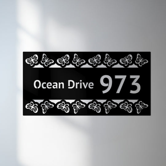 Crafted with durable metal, this butterfly border address sign exemplifies quality metal wall decor in a decorative house number plaque with street name display.