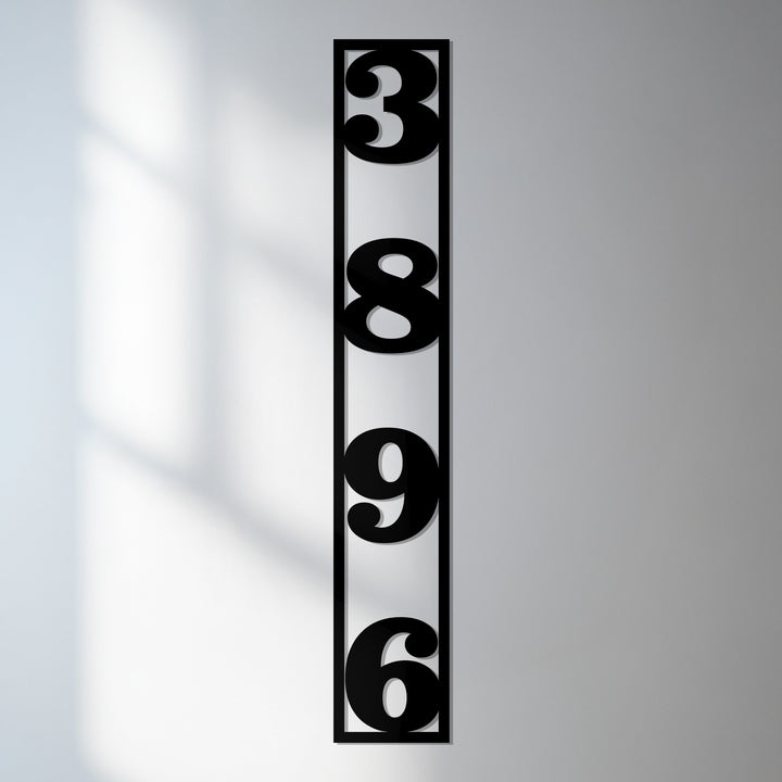 Vertical metal house numbers framed modern design