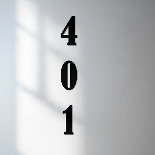 The stillness emphasizes a modern display of vertical metal house numbers, capturing the essence of minimalist decoration wall art for a contemporary home address.