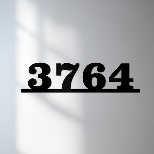Light and shadow interplay to highlight the sleek, floating design of these metal address numbers, showcasing modern metal artwork in a minimalist horizontal sign.