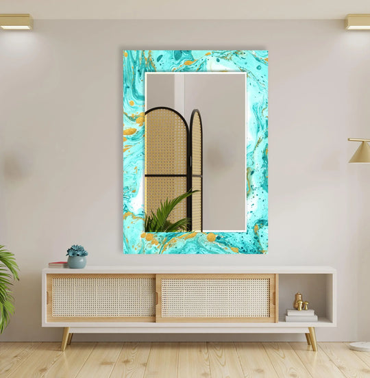 A vertical large wall mirror with a vibrant turquoise and gold abstract marble pattern reflects a rattan room divider and plant