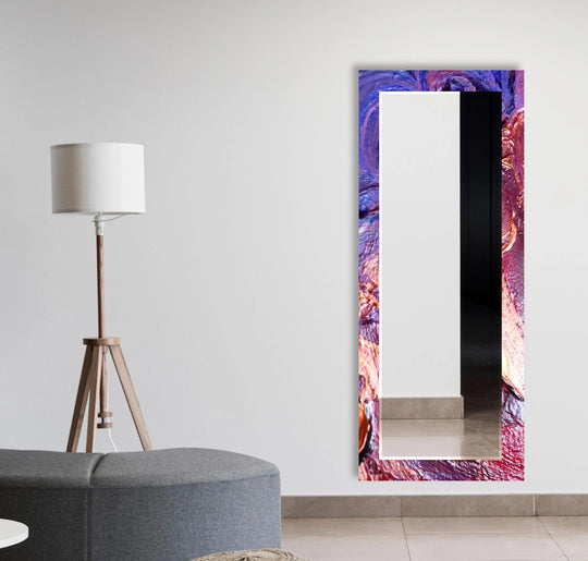 The long mirror features a purple and red stained frame and is a striking artistic wall mirror and stained glass mirror for any space