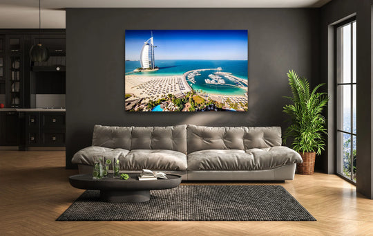 Featuring sleek edges and borders, this glass wall art presents an aerial view of Dubai's Burj Al Arab and luxury marina enhanced by vibrant glass printing.