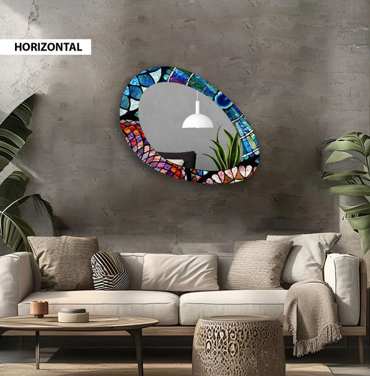 Stained glass finish details on the oval entryway framed wall mirror create a vibrant mosaic of color and texture, enhancing the looking glass.