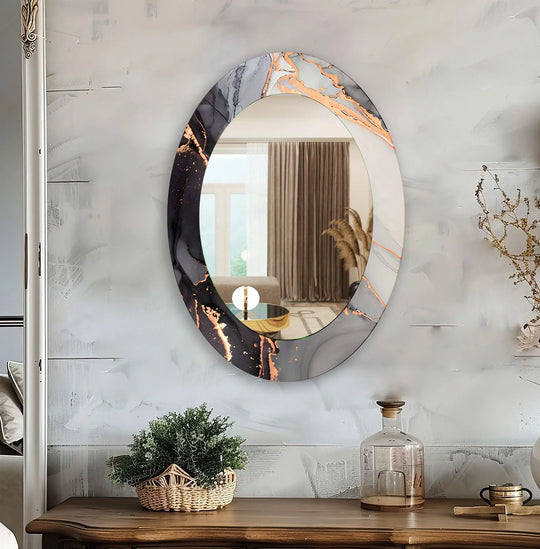 Asymmetric mirror showing a black white and gray abstract oval design with copper accents a decorative wall mirror on a white wall