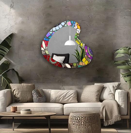 Intriguing light creates a contemplative mood around the colorful mosaic asymmetrical glass wall mirror, accentuating its modern wall mirrors design and reflective surface.
