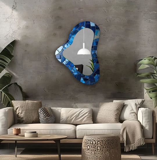 Undulating pieces give this blue decorative irregular glass wall mirror a feeling of fluid motion, offering a unique take on a modern mirror.