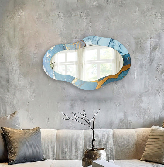 Negative space surrounds this gold blue decorative wall mirror, highlighting its unique shape as a stunning piece of mirror for wall decor.