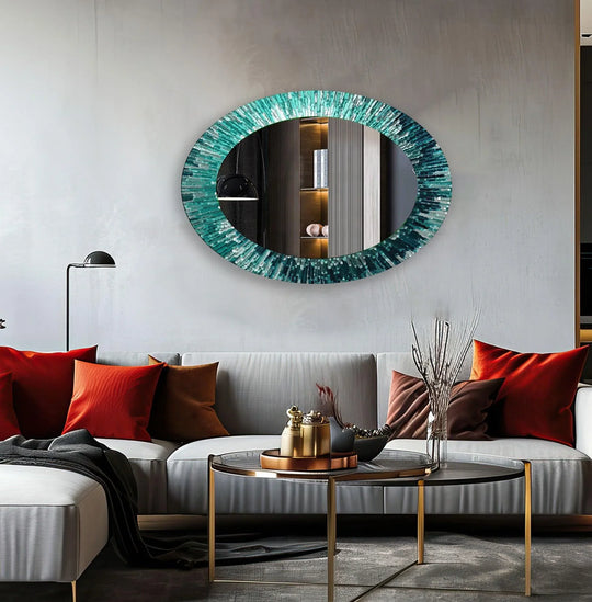 Light gray walls sharply contrast with the turquoise of a modern oval mirror for wall decor, creating an elegant focal point.
