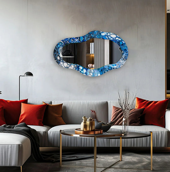 The darkest area reflects a modern living space within this blue stained glass wall mirror, showcasing its unique asymmetric design.