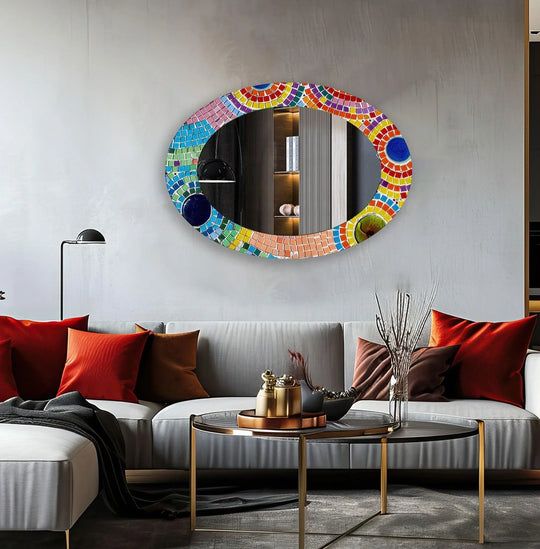 Shadows play across the Pink Mosaic Oval Wall Mirror, highlighting its intricate tilework and its function as a unique decorative mirror.