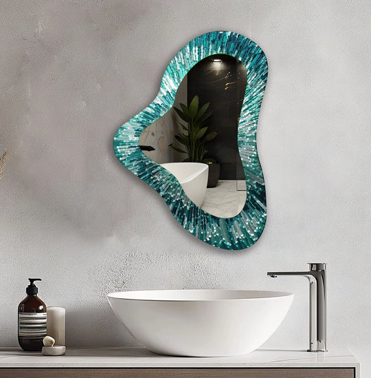 An asymmetric mirror features vibrant green abstract patterns and an organic shape reflecting a modern bathroom on a textured wall