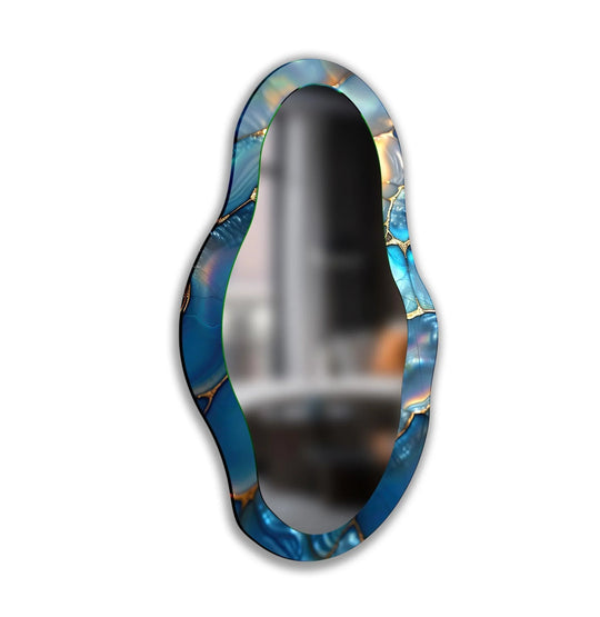 Stillness reflects in the blue metallic asymmetrical wall mirror, a piece of modern mirror offering a quiet contemplation of artistic design.