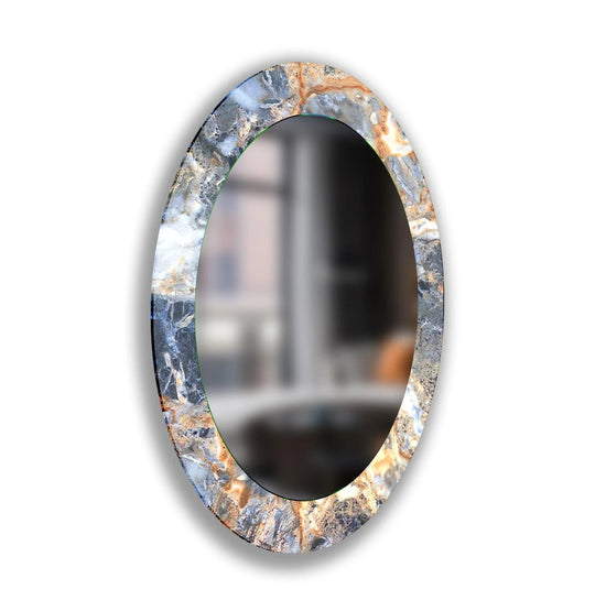 Dominant gray hues define this abstract oval wall mirror, suggesting contemporary decorating with wall mirrors, complemented by subtle copper accents and a sleek, frameless design.