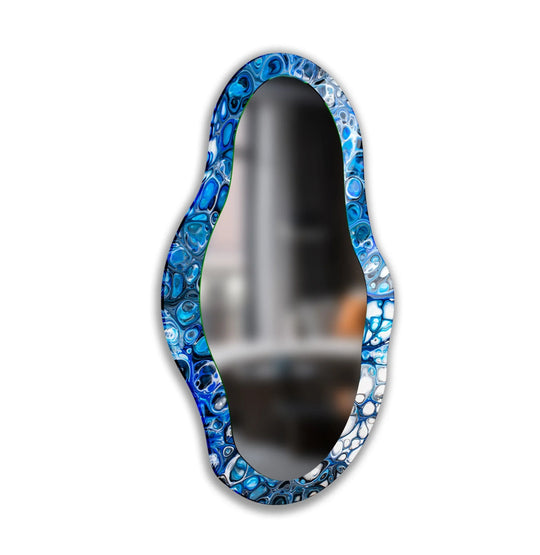 Surface texture reveals a swirling pattern of blues and whites across the decorative frame of this blue stained framed wall mirror.