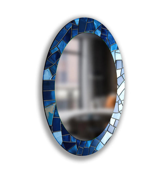 Detailed mosaic tiles of blue shades create a captivating foreground on this decorative oval wall mirror, a stylish addition to modern wall mirrors.