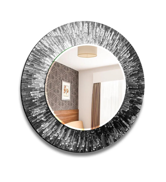 Round mirror features a modern sophisticated gray and black abstract textured frame reflecting a room interior on a white background
