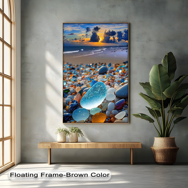 The richly saturated framed canvas features a vibrant sea glass beach with colorful pebbles, ocean waves, and a stunning coastal sunset wall art.