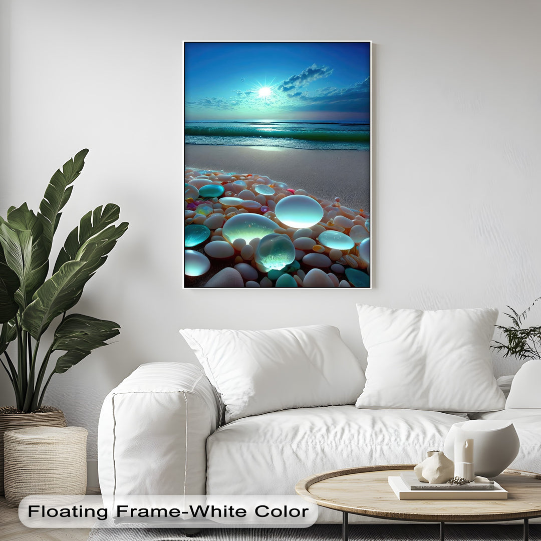 The detailed surface texture highlights the smooth, luminous pebbles, fine beach sand, and the gentle ocean waves on this vibrant framed canvas.