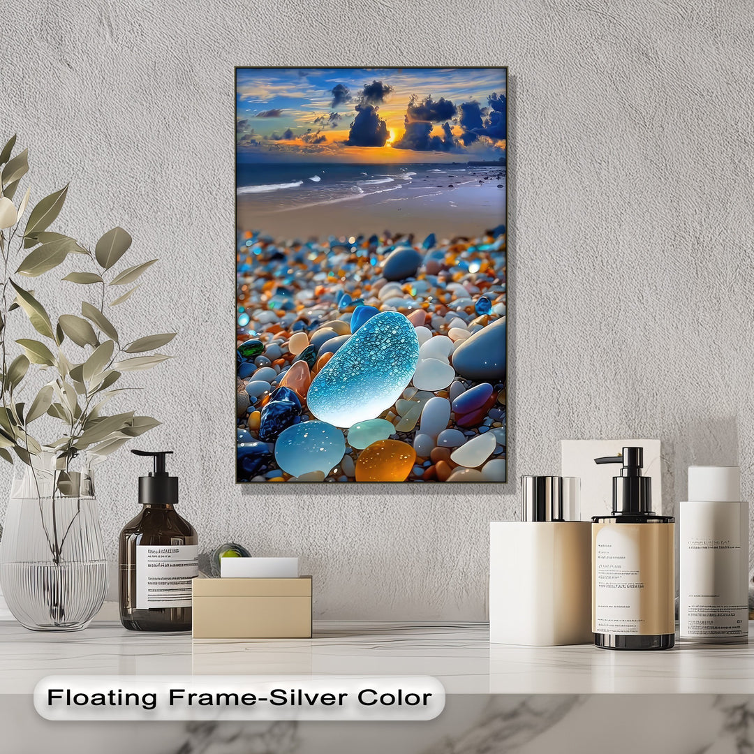 Glowing blue sea glass shines among vibrant beach pebbles, ocean waves, and a coastal sunset on this beautiful canvas art.