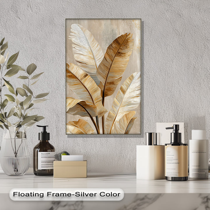 Softest brushstrokes define the golden tropical leaf art within the framed canvas print, depicting elegant neutral botanical wall art.