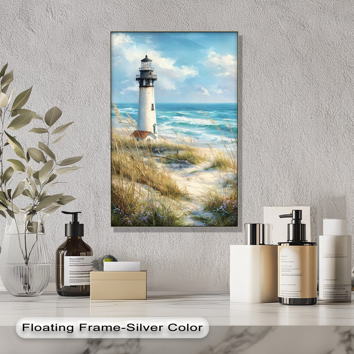 The stillness of the coastal lighthouse canvas artwork is captured with bright, tranquil sky above gentle ocean waves and sandy dunes.