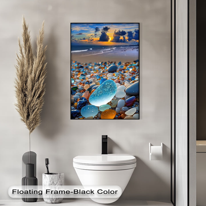 The sleek black border of this framed canvas highlights a vibrant coastal sunset over ocean waves and an array of colorful sea glass pebbles.