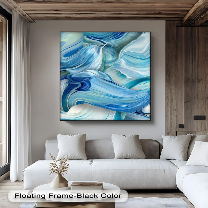 A calm and modern mood fills the room, accentuated by the serene canvas artwork featuring abstract blue and white flowing ocean wave patterns.
