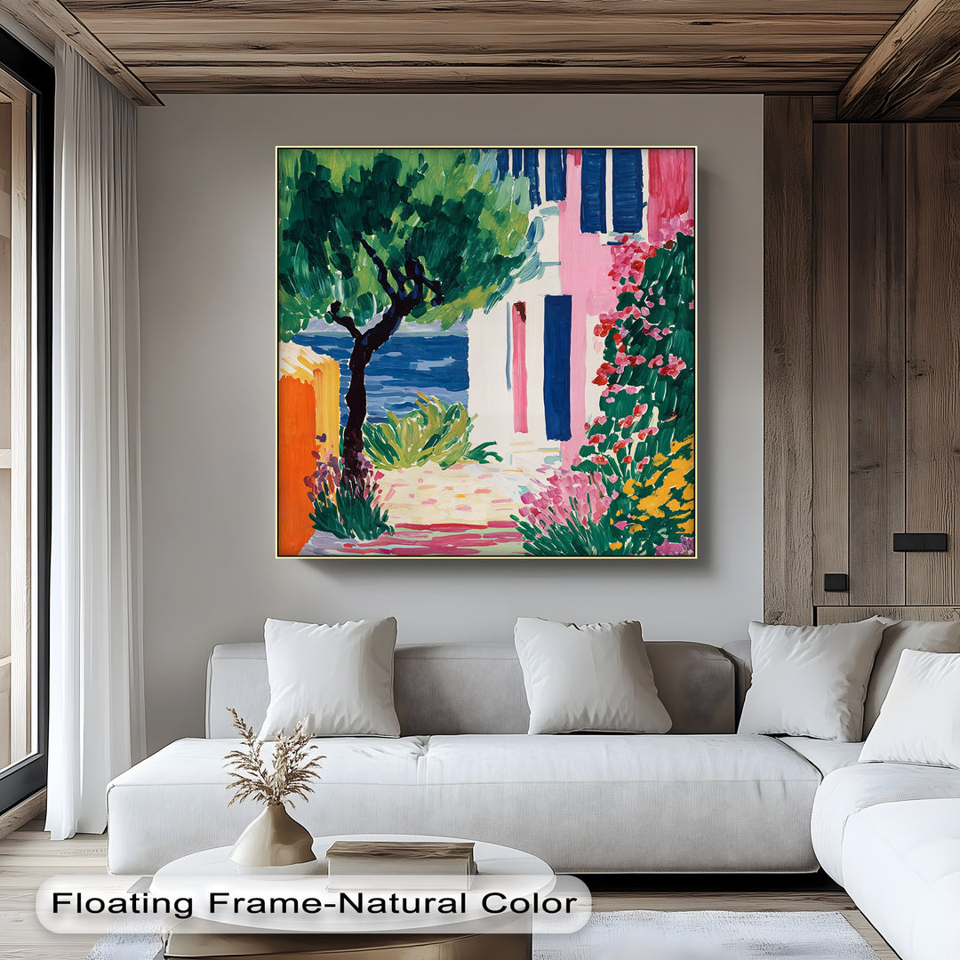 The focal point of this colorful Mediterranean village canvas wall art depicts a lush garden scene with vibrant flowers and an inviting glimpse of the sea.