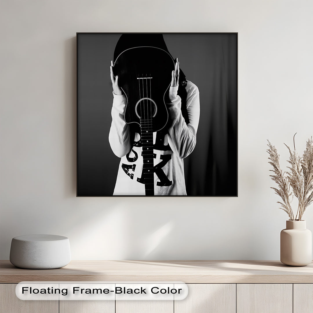 Let your decor sing with this artistic canvas painting of a faceless figure and bold guitar silhouette.

