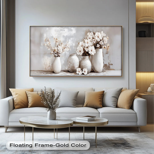 Foreground showcases a pair of marble-topped coffee tables before a Soft Bloom Harmony neutral floral vases canvas wall art displayed above a modern sofa.