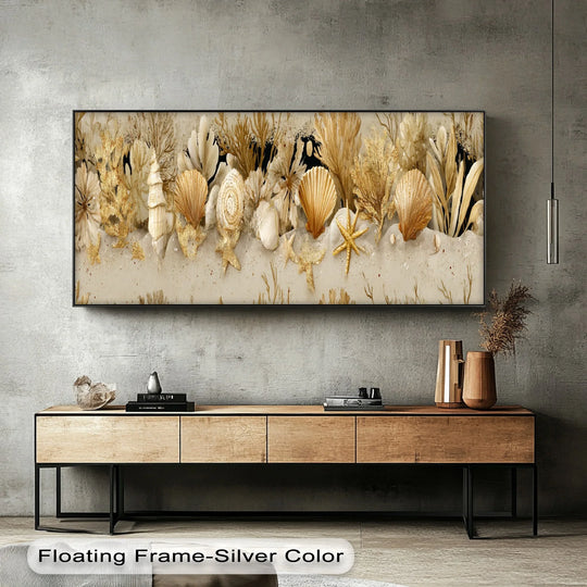 The focal point shows a coastal seashell and coral canvas painting in a black floating frame, bringing the golden shoreline to life with its textured details.
