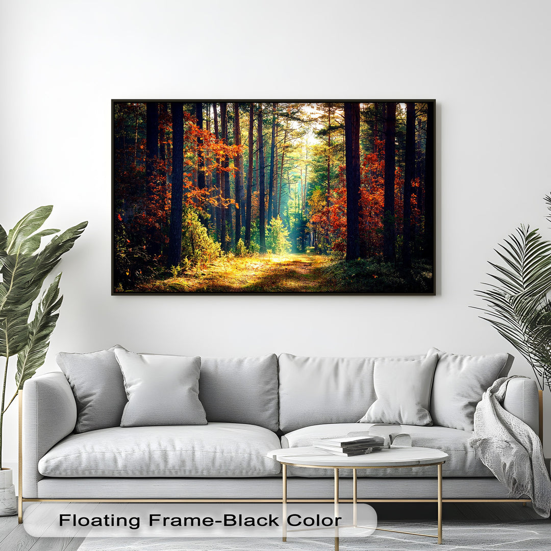 The negative space of a bright white wall accentuates the vibrant hues of the autumn forest framed canvas, a sunlit nature path wall art piece.