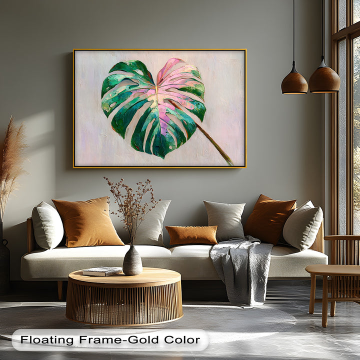 Warm light illuminates the pink monstera leaf canvas wall decor, contrasting with cooler shadows on the textured, modern botanical print.